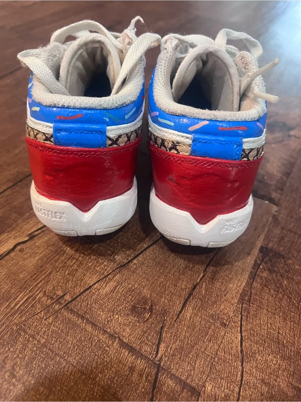 Nike Kids White Sneakers with Red & Blue Accents